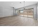 Bright, open living area with wood floors, recessed lights, and sliding glass doors offering backyard views at 23161 E Mockingbird Dr, Queen Creek, AZ 85142