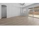 Bright living room with neutral paint, ceiling fan, and sliding glass doors to backyard at 23161 E Mockingbird Dr, Queen Creek, AZ 85142