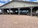 Spacious outdoor pavilion features stone fireplace, ample seating, and brick paved flooring at 23161 E Mockingbird Dr, Queen Creek, AZ 85142