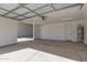 Interior view of garage with concrete floors and door to home at 24032 W Redbird Rd, Wittmann, AZ 85361