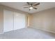 Bright bedroom featuring a ceiling fan and a large closet with sliding doors at 25822 S Boxwood Dr, Sun Lakes, AZ 85248