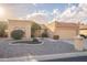 Home's exterior features desert landscaping, a two-car garage, and a neutral stucco facade at 25822 S Boxwood Dr, Sun Lakes, AZ 85248