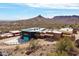 Remote desert home featuring multiple buildings, a large drive, and stunning mountain views at 27194 N Bear Paw Pass, San Tan Valley, AZ 85144