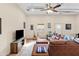 Comfortable living room with leather furniture, a ceiling fan, and tile flooring at 27194 N Bear Paw Pass, San Tan Valley, AZ 85144