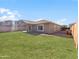 Backyard with a grassy area, covered patio, and block wall fence at 29219 N Red Finch Dr, San Tan Valley, AZ 85143