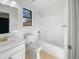 Bathroom featuring a shower-tub combo, tile flooring, and a mirrored vanity at 29219 N Red Finch Dr, San Tan Valley, AZ 85143