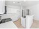 Bright kitchen features all white cabinets and appliances, as well as tile floors at 29219 N Red Finch Dr, San Tan Valley, AZ 85143