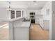 Bright kitchen with white cabinetry, stainless steel appliances, tile flooring, and breakfast bar at 29219 N Red Finch Dr, San Tan Valley, AZ 85143