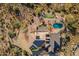 Birds eye view of the property showcasing the pool, backyard putting green, desert landscaping and home's roof at 3086 N Herrala Way, Apache Junction, AZ 85119