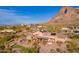 Aerial view of the pool, putting green, patio and home with a backdrop of beautiful desert scenery at 3086 N Herrala Way, Apache Junction, AZ 85119