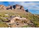 Picture of the backyard pool, putting green, patio and home with a view of mountains in the distance at 3086 N Herrala Way, Apache Junction, AZ 85119