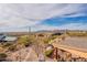 Expansive backyard with desert landscaping, a putting green, and stunning mountain views at 3086 N Herrala Way, Apache Junction, AZ 85119
