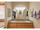 Bathroom featuring double sinks with granite countertop and framed oval mirrors at 3086 N Herrala Way, Apache Junction, AZ 85119
