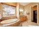 Bright bathroom with a soaking tub overlooking the view and double sinks at 3086 N Herrala Way, Apache Junction, AZ 85119