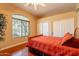 Bedroom with a large window, wood floors, and double closet at 3086 N Herrala Way, Apache Junction, AZ 85119