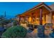 Inviting covered patio with stone accents, wood beams, stylish seating, and a cozy fire pit, perfect for outdoor relaxation at 3086 N Herrala Way, Apache Junction, AZ 85119