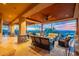 Spacious covered patio with multiple seating areas, desert views, stone pillars, and a wood ceiling at 3086 N Herrala Way, Apache Junction, AZ 85119