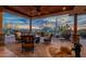 Inviting covered patio features a stone fire pit, desert landscaping, and stunning sunset views at 3086 N Herrala Way, Apache Junction, AZ 85119