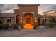 Stunning entryway with arched doorway, stone accents, and warm lighting, creating a welcoming and luxurious ambiance at 3086 N Herrala Way, Apache Junction, AZ 85119