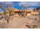 Charming exterior with desert landscaping, stone accents, and a paved walkway leading to a covered patio at 3086 N Herrala Way, Apache Junction, AZ 85119