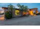 Exterior home view showcasing desert landscaping, an arched entry, and warm lighting at 3086 N Herrala Way, Apache Junction, AZ 85119