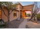Elegant front exterior showcasing desert landscaping, a stone pathway, and architectural details that enhance its curb appeal at 3086 N Herrala Way, Apache Junction, AZ 85119