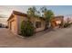Exterior home view showcasing desert landscaping, an arched entry, and warm lighting at 3086 N Herrala Way, Apache Junction, AZ 85119