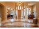 Grand foyer with soaring ceilings, elegant tile flooring, and abundant natural light, creating a sophisticated entrance at 3086 N Herrala Way, Apache Junction, AZ 85119