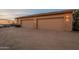 Exterior shot of a three-car garage featuring landscape lighting and ample parking space at 3086 N Herrala Way, Apache Junction, AZ 85119