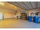 Well-lit garage with epoxy floor, built in cabinets, storage racks, and a window at 3086 N Herrala Way, Apache Junction, AZ 85119