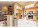 Kitchen features granite countertops, light cabinets and appliances, and tile floors at 3086 N Herrala Way, Apache Junction, AZ 85119