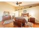 Comfortable main bedroom with a large window, wood floors, and traditional furnishings at 3086 N Herrala Way, Apache Junction, AZ 85119