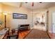 Office room with rich wood floors and open doorway to the living room at 3086 N Herrala Way, Apache Junction, AZ 85119