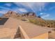 Roof with solar panel featuring scenic mountain views, desert plants, and natural light at 3086 N Herrala Way, Apache Junction, AZ 85119
