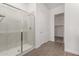 Bathroom featuring a glass-enclosed shower, tile flooring, and access to a walk-in closet at 31476 N Hayweather Ln, San Tan Valley, AZ 85143