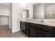 Bathroom featuring dual sinks, a large mirror and plenty of counter space at 31476 N Hayweather Ln, San Tan Valley, AZ 85143