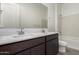 Bathroom features a double sink vanity, large mirror, and bathtub at 31476 N Hayweather Ln, San Tan Valley, AZ 85143