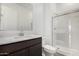 Bathroom featuring modern vanity with a marble-walled glass shower, combining style and functionality at 31476 N Hayweather Ln, San Tan Valley, AZ 85143