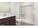 Bathroom featuring a dark cabinet vanity, a white toilet, and glass enclosed shower at 31476 N Hayweather Ln, San Tan Valley, AZ 85143