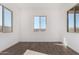 Bright and spacious bedroom with three windows and tile flooring at 31476 N Hayweather Ln, San Tan Valley, AZ 85143