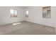 Spacious bedroom with neutral carpet, three windows, and ample natural light at 31476 N Hayweather Ln, San Tan Valley, AZ 85143
