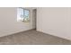 Bedroom featuring carpeted flooring, window with views, and neutral color palette at 31476 N Hayweather Ln, San Tan Valley, AZ 85143