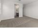 Expansive bedroom with plush carpet and en-suite bathroom entrance, offering a private retreat at 31476 N Hayweather Ln, San Tan Valley, AZ 85143