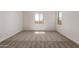 Bright and airy bedroom with carpet and two windows at 31476 N Hayweather Ln, San Tan Valley, AZ 85143
