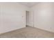 Bedroom with neutral carpet, white walls, and open doorway to another room at 31476 N Hayweather Ln, San Tan Valley, AZ 85143