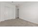 Bedroom with closet and entryway, carpeted flooring, and neutral color palette at 31476 N Hayweather Ln, San Tan Valley, AZ 85143