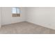 Bright bedroom with carpet, a window, and modern interior design at 31476 N Hayweather Ln, San Tan Valley, AZ 85143