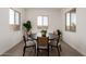 Bright dining room with modern table and chairs, surrounded by ample natural light at 31476 N Hayweather Ln, San Tan Valley, AZ 85143