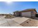 New construction home featuring a concrete driveway, two-car garage, and low maintenance desert landscaping at 31476 N Hayweather Ln, San Tan Valley, AZ 85143