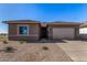 New construction home features a two-car garage, neutral stucco exterior, and low maintenance desert landscaping at 31476 N Hayweather Ln, San Tan Valley, AZ 85143